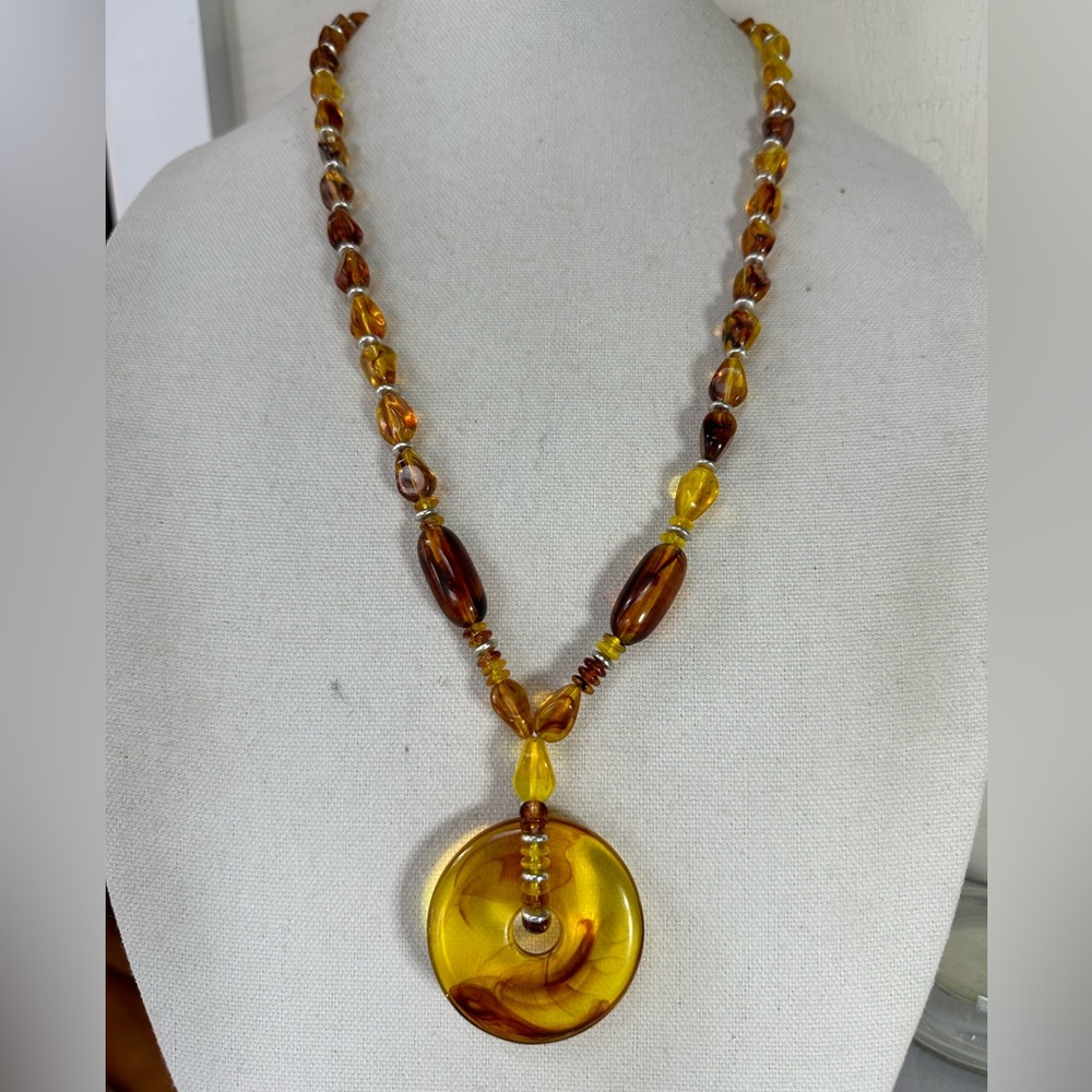 Unusual unique swirled amber colored statement necklace